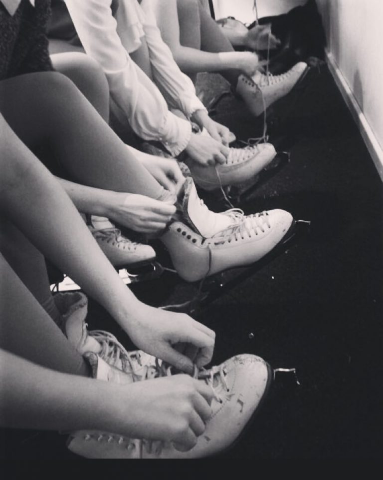 Skaters tying their boots ahead of their ice skating lessons.